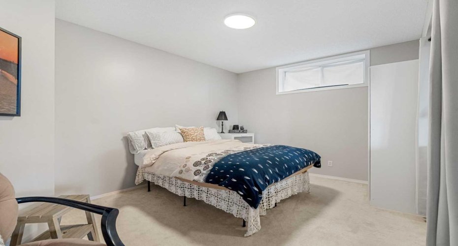 2nd bedroom with armoire that could easily function as a guest space, or office.