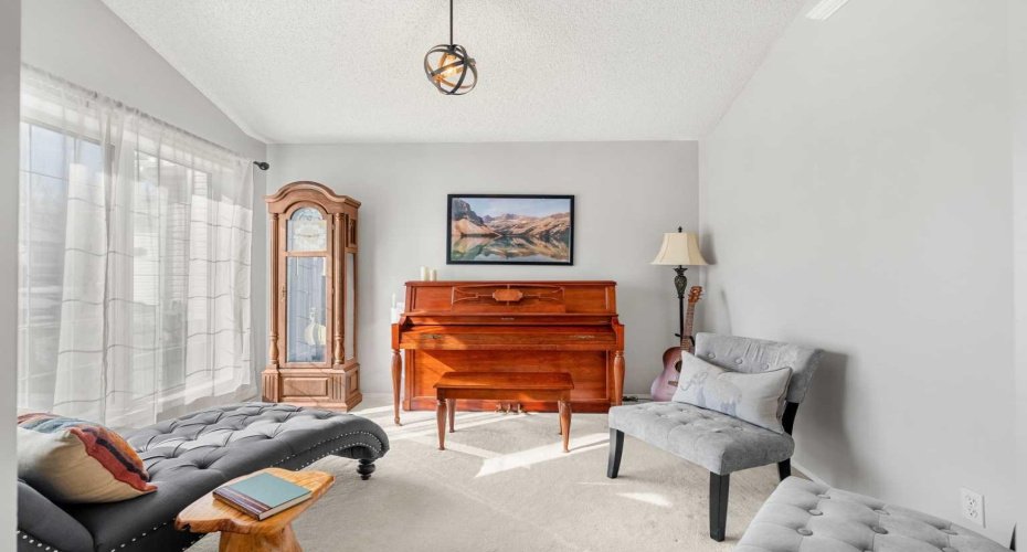 From the front foyer, you’re greeted by soaring vaulted ceilings, hardwood flooring, and a clear line of sight to the living area.
