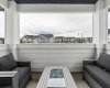 A covered front balcony allows your to take in the fresh air no matter the weather