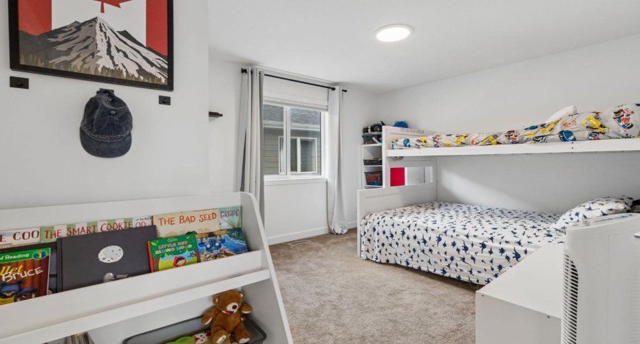 Bedroom 3, keeps the space open and airy with a large window and lots of space to feel at home