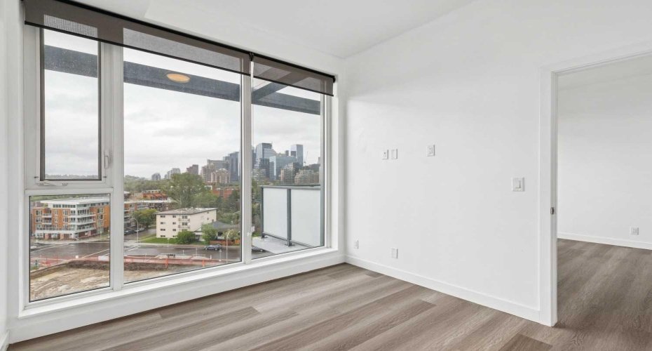 Alternate view of primary bedroom with downtown views