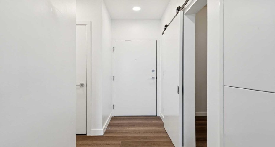 Foyer with barn door to the secondary bedroom