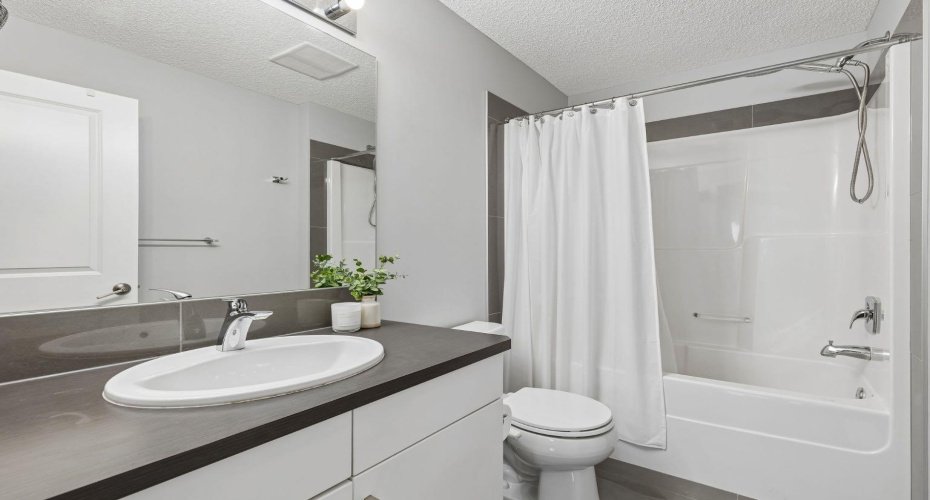 Enjoy the convenience of a private ensuite designed for everyday comfort. Clean lines, modern finishes, and a full tub and shower combination create a functional space that makes busy mornings and relaxing evenings effortless.