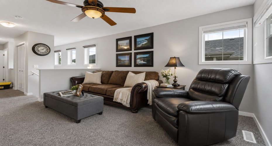 Separate from the main floor entertaining spaces, this inviting bonus room provides the perfect balance of togetherness and privacy. Large windows bring in natural light, creating a bright and welcoming environment for relaxation, work, hobbies, or family time.
