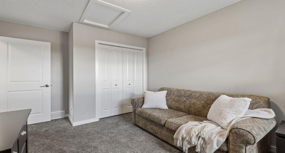 Versatile and welcoming, this secondary bedroom is perfectly suited for family, guests, a home office, or hobby space. Large windows and a neutral palette create a bright, comfortable setting that can easily adapt to your lifestyle.A spacious and flexible bedroom offering room to grow, work, or unwind. Thoughtfully designed with generous closet space and soft natural light, this room is ready to meet a variety of needs.