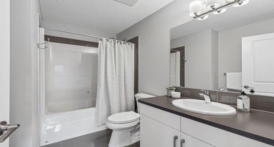 Designed with both style and functionality in mind, this upper level full bathroom features modern finishes, generous counter space, and a clean, contemporary aesthetic that serves family members and guests with ease.