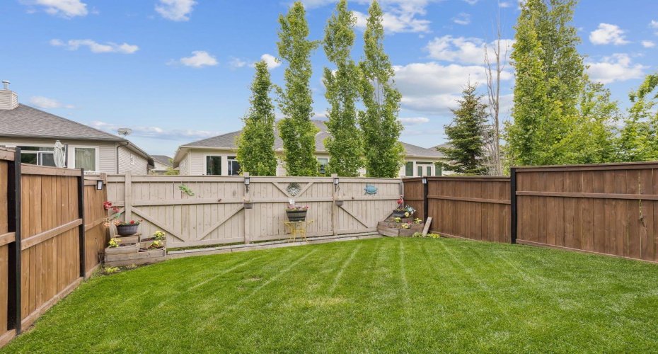 The fully fenced backyard provides a secure and low-maintenance outdoor space for children, pets, gardening, or simply enjoying sunny afternoons. Mature trees and thoughtful landscaping add charm and privacy.