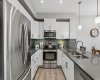 Clean lines, contemporary finishes, and a highly functional layout make everyday living feel effortless. With generous cabinetry, stainless steel appliances, and ample counter space, everything you need is within easy reach while maintaining a bright, modern aesthetic.