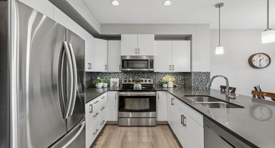 Clean lines, contemporary finishes, and a highly functional layout make everyday living feel effortless. With generous cabinetry, stainless steel appliances, and ample counter space, everything you need is within easy reach while maintaining a bright, modern aesthetic.