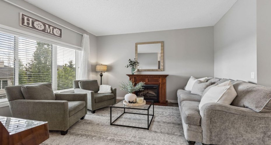 Comfort and connection come together in this inviting living room. Whether you're hosting friends, enjoying family movie nights, or curling up with a good book beside the fireplace, this space effortlessly adapts to every season of life.