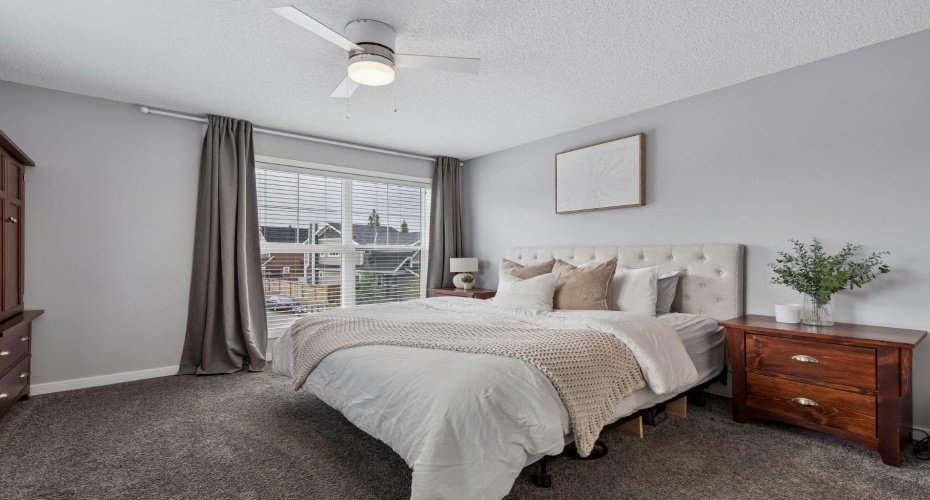End each day in the comfort of your own private retreat. Spacious and filled with natural light, the primary bedroom offers a peaceful atmosphere designed for rest and relaxation, with plenty of room to create your ideal sanctuary.