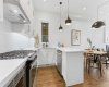 Window over your sink, beautiful pendant lights and island with seating space