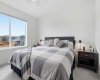 Bright and open primary bedroom with large East Facing windows.