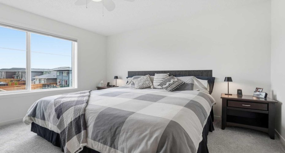 Bright and open primary bedroom with large East Facing windows.