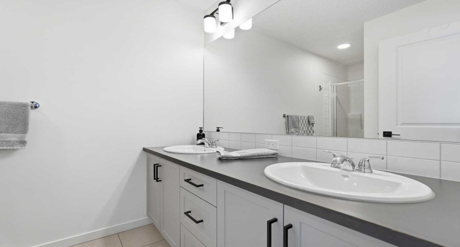 Primary ensuite with double vanities.