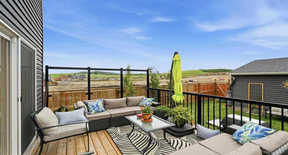 Large, fully landscaped west facing backyard with extended raised deck.