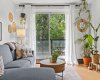 Bright living room with large windows and direct access to the private balcony.