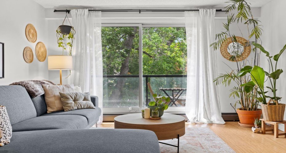Bright living room with large windows and direct access to the private balcony.