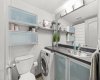 Updated bathroom complete with modern finishes, vanity storage, and in-suite laundry.