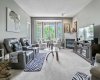 Living room with corner gas fireplace and a large window