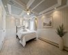 Relax in the spacious primary bedroom, a comfortable retreat at the end of the day. (Wall accents virtually staged).