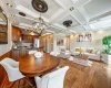 A spacious open-concept layout seamlessly connects the kitchen, dining, & living areas, creating the perfect setting for entertaining. (Sofa & décor accents virtually staged).