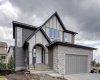Front of Home with Double Attached Garage and Concrete Driveway