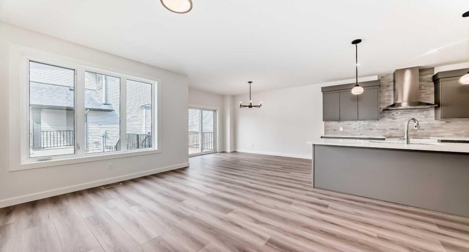 View from Great Room to Kitchen and Dining Nook • • PLEASE NOTE: Kitchen appliances are included, and will be installed prior to possession.