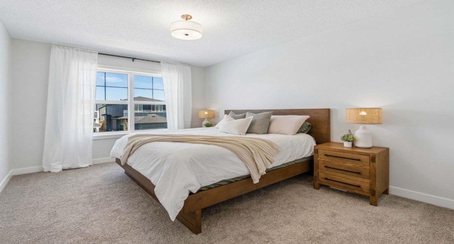 Escape to a spacious primary retreat where soft natural light, generous proportions, and calming finishes create the perfect place to begin and end each day