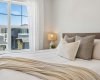 Wake up to sunshine streaming through oversized windows and enjoy the peaceful atmosphere of a bedroom designed with comfort, relaxation, and everyday luxury in mind.