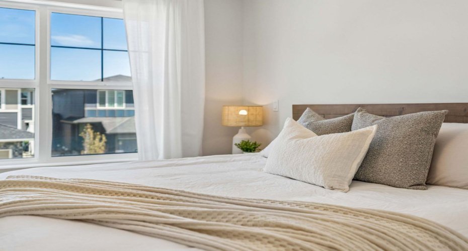 Wake up to sunshine streaming through oversized windows and enjoy the peaceful atmosphere of a bedroom designed with comfort, relaxation, and everyday luxury in mind.