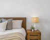 Every detail invites you to slow down—from the cozy layered bedding to the warm natural finishes—creating a space that feels both elevated and inviting.
