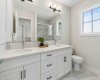 Start your mornings with ease in this beautifully finished ensuite featuring dual vanities, quartz countertops, elegant tilework, and plenty of room to simplify busy routines.