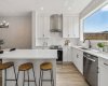 Whether you're preparing family meals or hosting friends, the oversized quartz island provides the perfect gathering space, complemented by timeless finishes, abundant cabinetry, and a seamless open-concept layout.