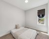 A welcoming secondary bedroom filled with natural light provides the perfect retreat for family members or overnight guests, with plenty of room to grow and personalize.
