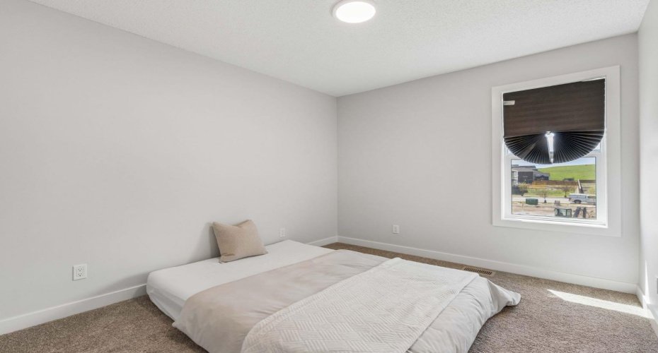 A welcoming secondary bedroom filled with natural light provides the perfect retreat for family members or overnight guests, with plenty of room to grow and personalize.
