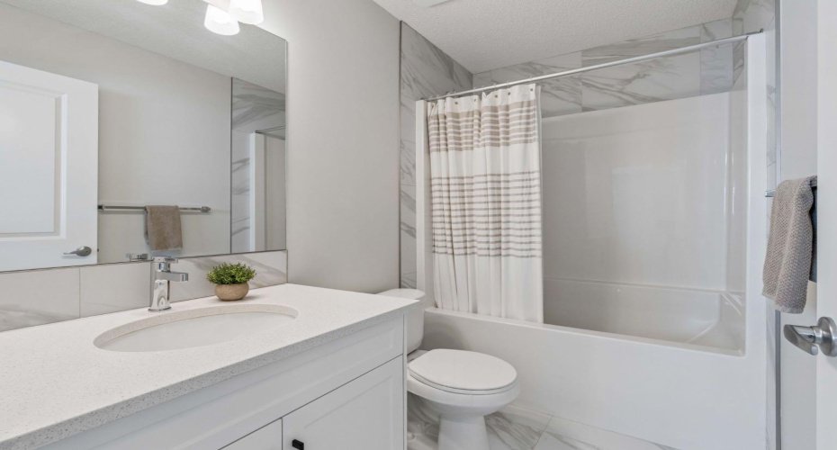 Beautifully finished with timeless finishes, this upper level 4 piece full bathroom features quartz countertops, stylish tile work, and a functional layout designed to make busy mornings a breeze.