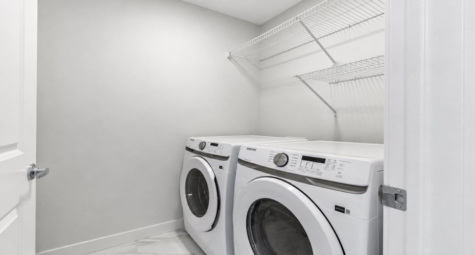 Conveniently located on the upper level, the dedicated laundry room keeps daily routines simple with side-by-side appliances, built-in shelving, and plenty of storage space.