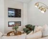 Settle in and unwind around the sleek electric fireplace, where contemporary design and a warm ambiance create the perfect setting for cozy evenings, movie nights, or gathering with loved ones.