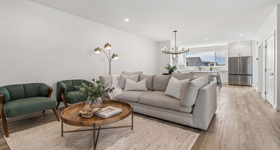 Designed for both relaxing evenings and entertaining, the inviting living room features an open-concept layout that seamlessly connects to the kitchen and dining area, creating the perfect space to gather with family and friends.