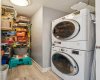 Separate laundry room with storage and stack washer/dryer.