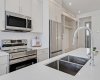 Modern kitchen with quartz counters and stainless steel appliances