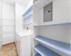 So much storage space with a separate laundry room complete with shelving!