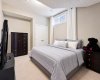 Lower level bedroom bedding virtually staged