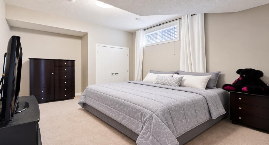 Lower level bedroom bedding virtually staged