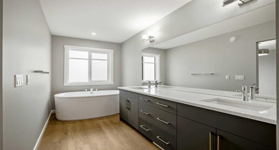 Primary ensuite bathroom with soaker tub and dual vanities - the home is under construction, so images are of a similar build for illustration purposes.