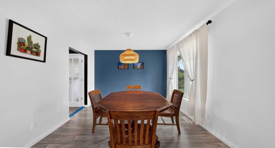Dining room filled with natural light from expansive windows