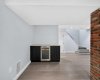 a built-in continental bar with a high-end wine cooler