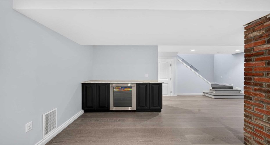 a built-in continental bar with a high-end wine cooler