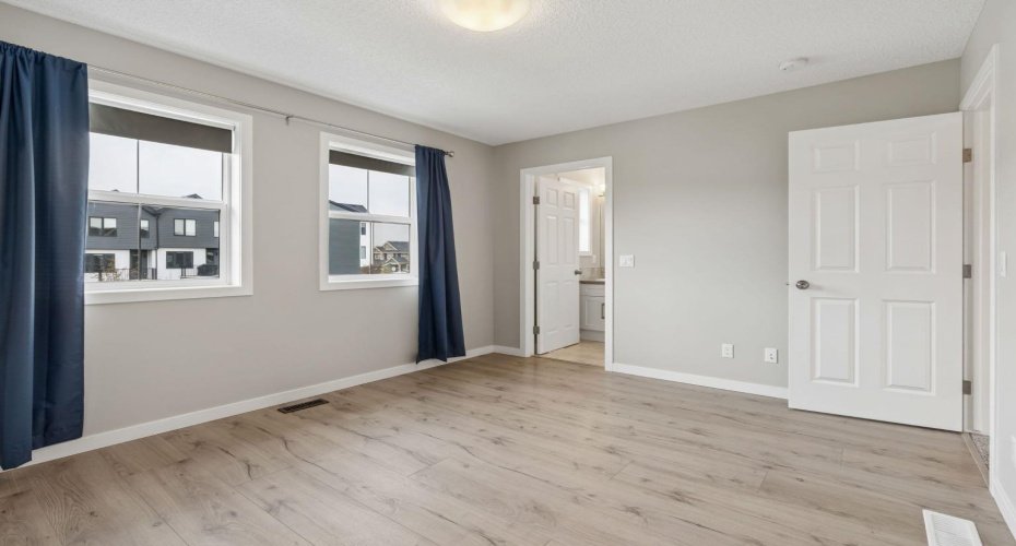 Spacious enough for a king-sized suite and thoughtfully designed for everyday comfort, the primary bedroom offers a peaceful escape complete with convenient access to the ensuite.
